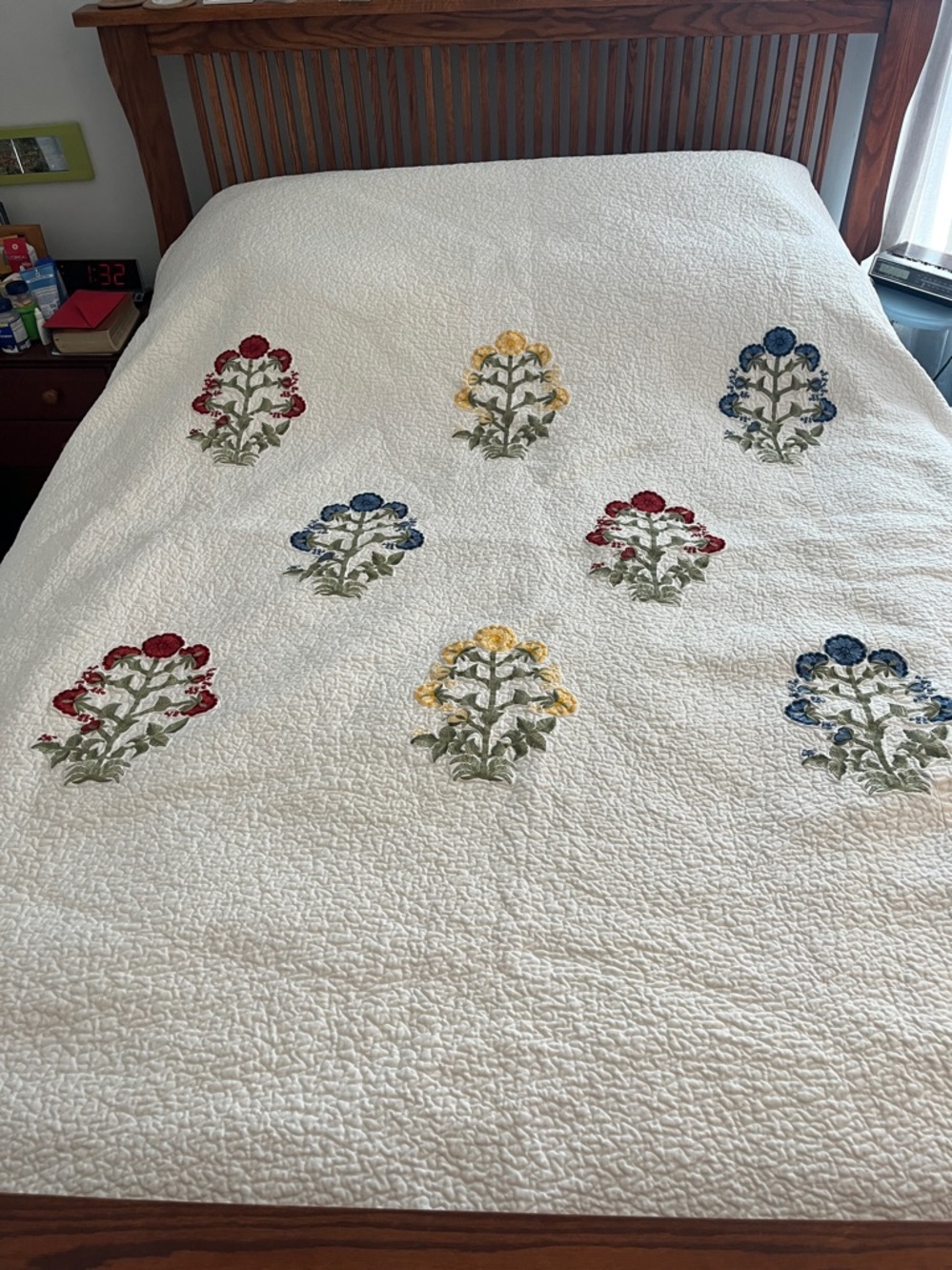 Pottery Barn White Quilt with Red, Yellow, Blue and Green Floral Embroidery.